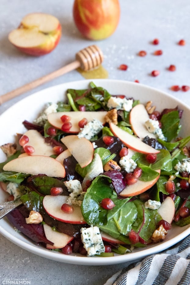 Apple and blue cheese salad in a large white serving plate