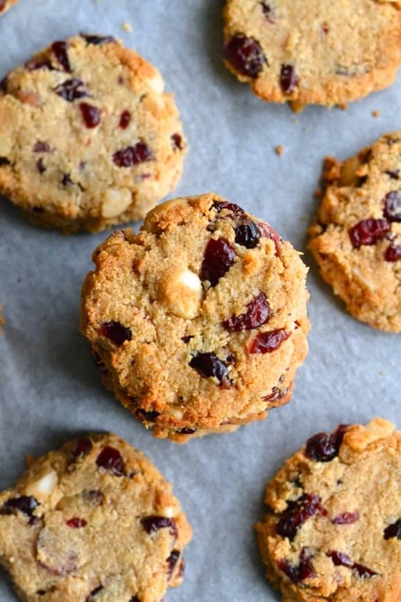 Gluten free, sugar free and dairy free paleo cookies with dried cranberries and macadamias arranged on a baking tray (paleo cookies recipe)