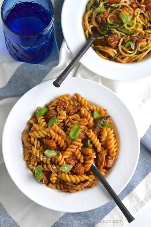 two bowls of Italian Sausage Pasta - one with fusilli noodles, one with zoodles