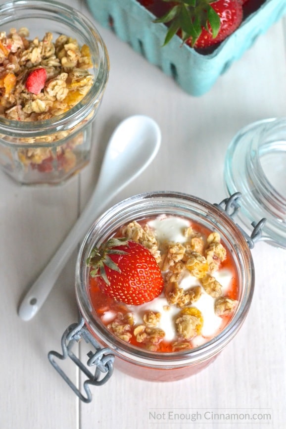 overhead shot of a Rhubarb and strawberry chia pudding breakfast served in a mason jar with a white spoon on the side