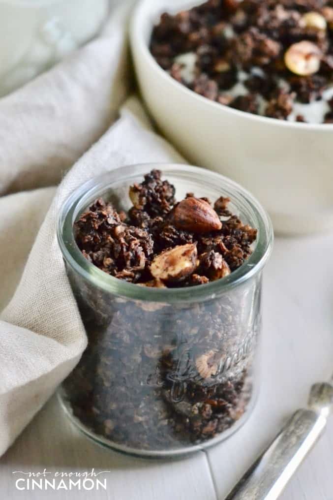close-up of a small glass jar of homemade chocolate hazelnut granola