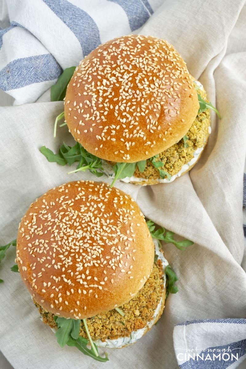 overhead shot of two vegetarian falafel burgers with falafel patties and arugula