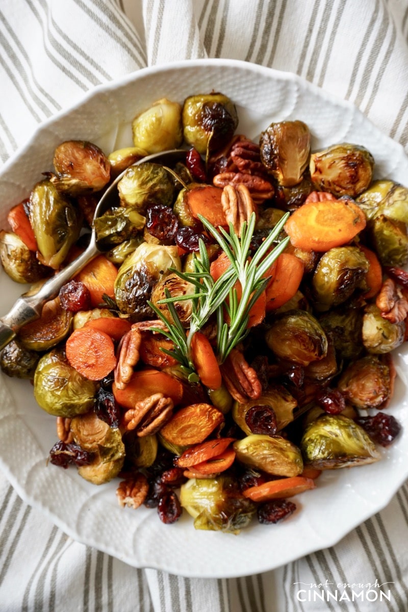 overhead shot of maple roasted vegetables with balsamic vinegar, rosemary and pecans