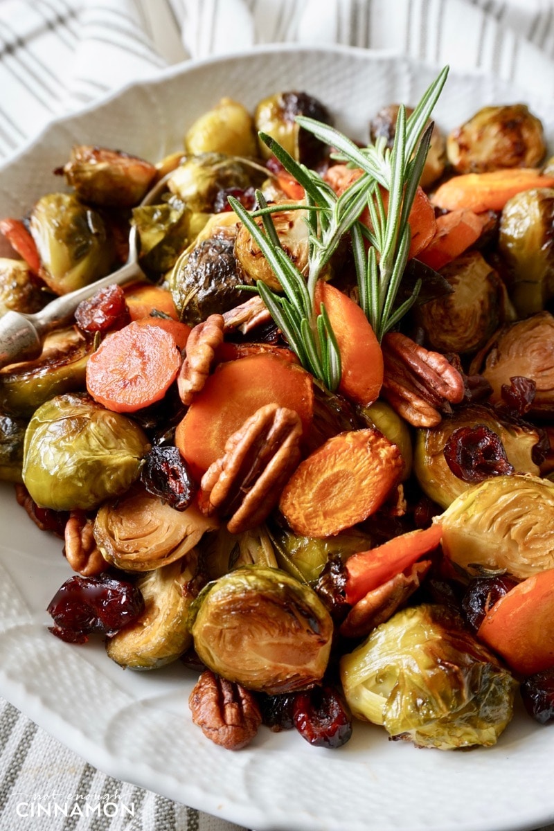 close-up of a plate with balsamic and maple roasted Brussels sprouts and carrots with pecans