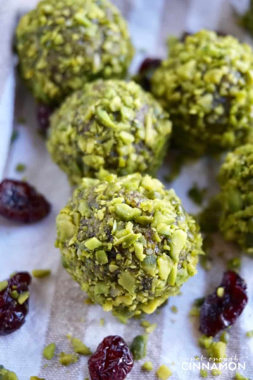 close-up of paleo energy balls with cranberries and chopped pistachios