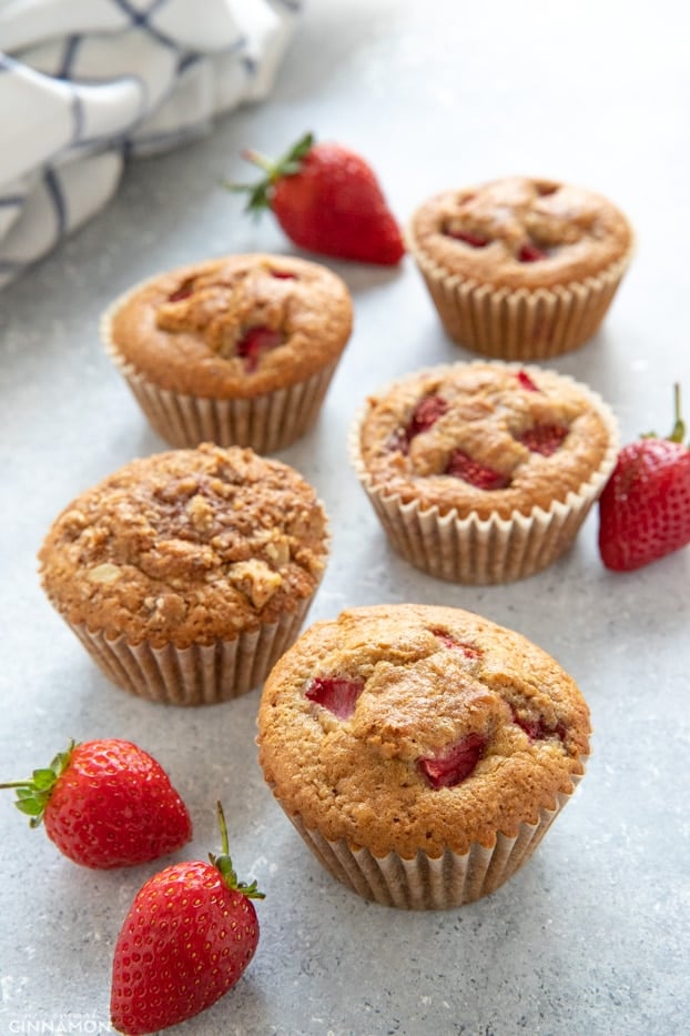 strawberry muffins with and without streusel topping, with a stripped kitchen cloth