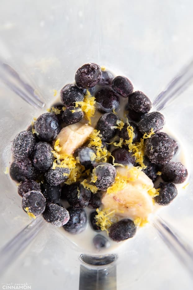 Frozen blueberries, banana and lemon zest in a blender