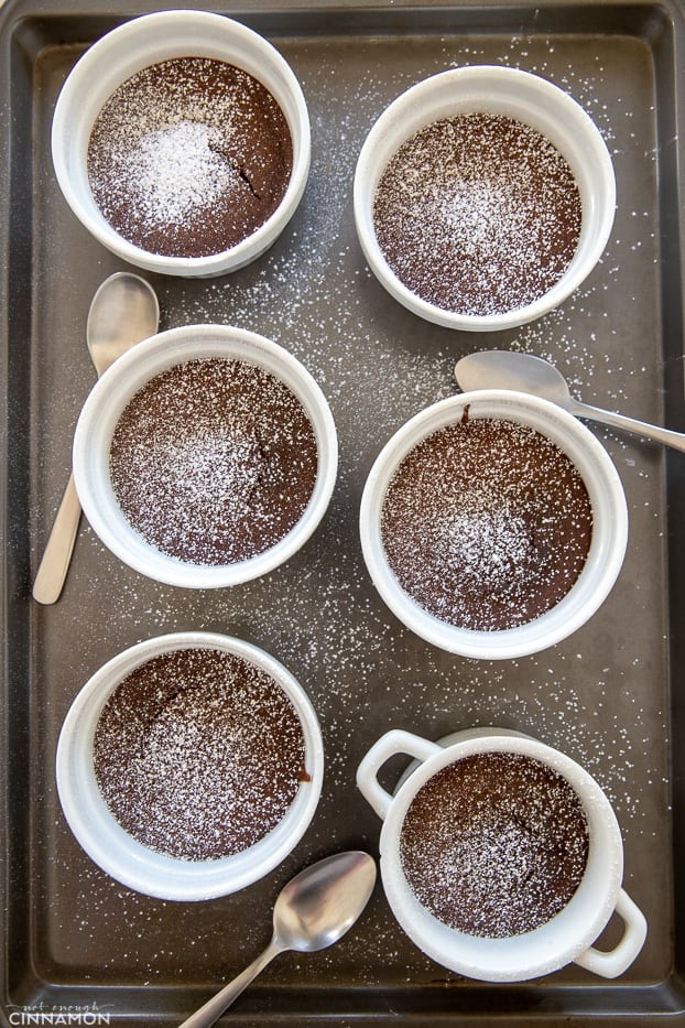 overhead shot of 6 individual sized chocolate lava cakes dusted with icing sugar