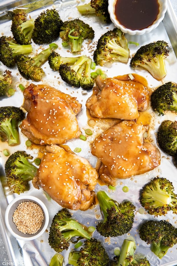 overhead shot of sheet pan chicken thighs with teriyaki glaze and broccoli on a sheet pan