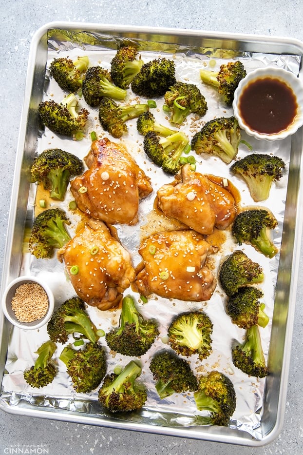 overhead shot of an Asian chicken sheet pan dinner consisting of teriyaki chicken thighs and charred broccoli