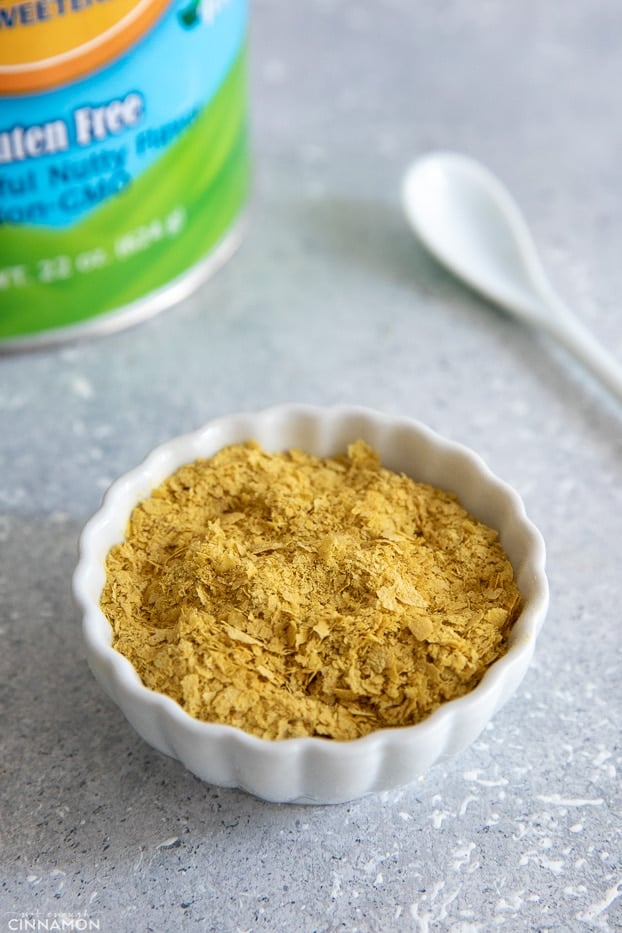 nutritional yeast flakes in a small white dish 
