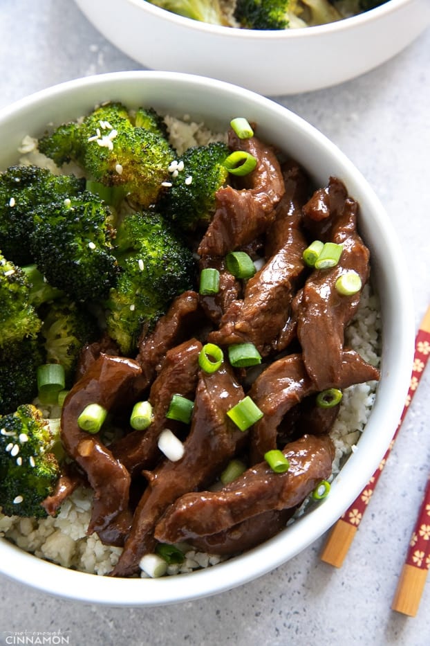 close-up of a bowl of healthy Slow Cooker Mongolian Beef and Broccoli served over low carb cauliflower rice