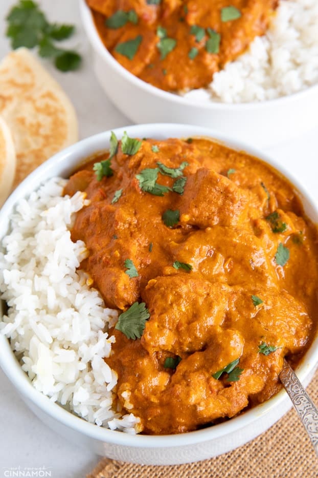 a serving of healthy dairy-free paleo slow cooker butter chicken served with rice and fresh cilantro 