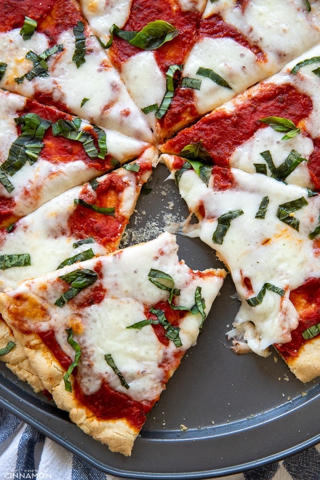 overhead shot of a half eaten paleo almond flour crust pizza Margherita 