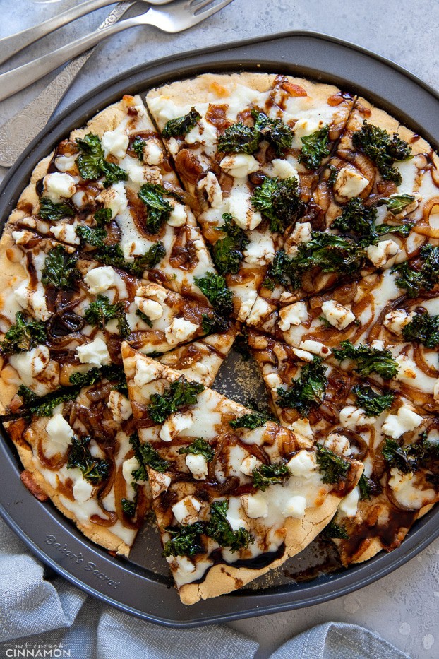 overhead shot of gluten-free pizza topped with goat cheese, caramelized goat cheese and caramelized onions 