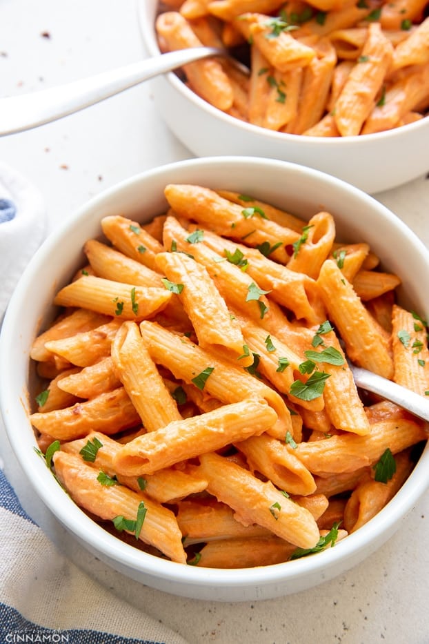 close-up of a bowl of vegan penne vodka sprinkled with parsley