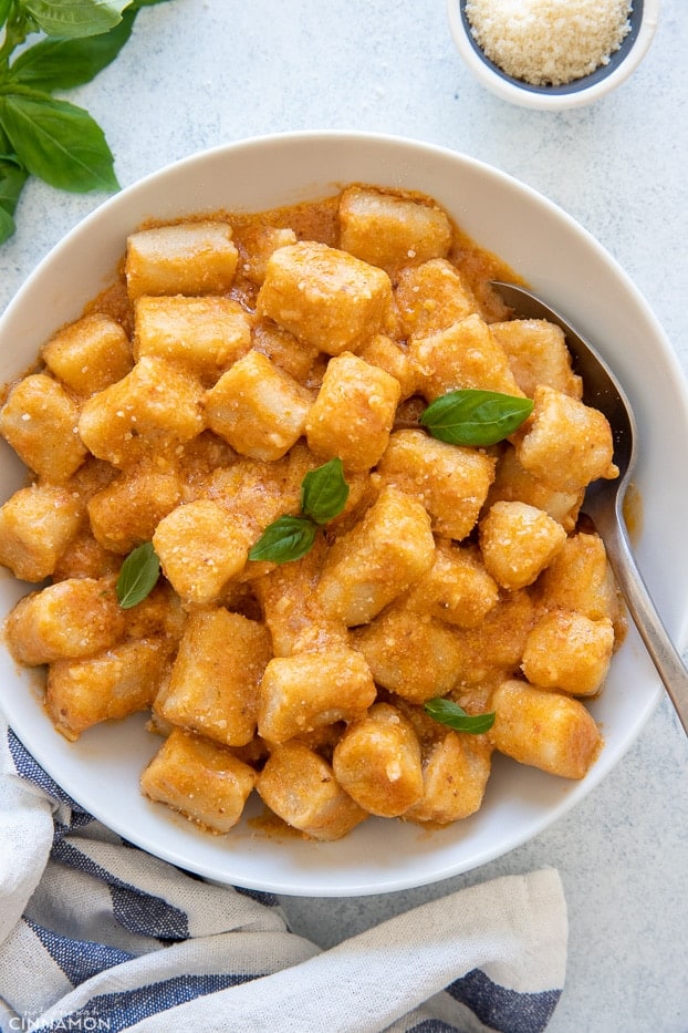 overhead shot of a bowl of healthy cauliflower gnocchi tossed with sun-dried tomato sauce