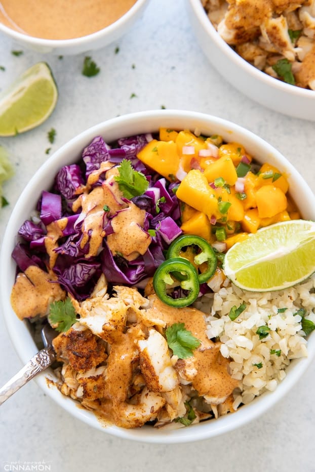 overhead shot of a healthy whole30 fish taco bowl with cauliflower rice and chipotle mayo