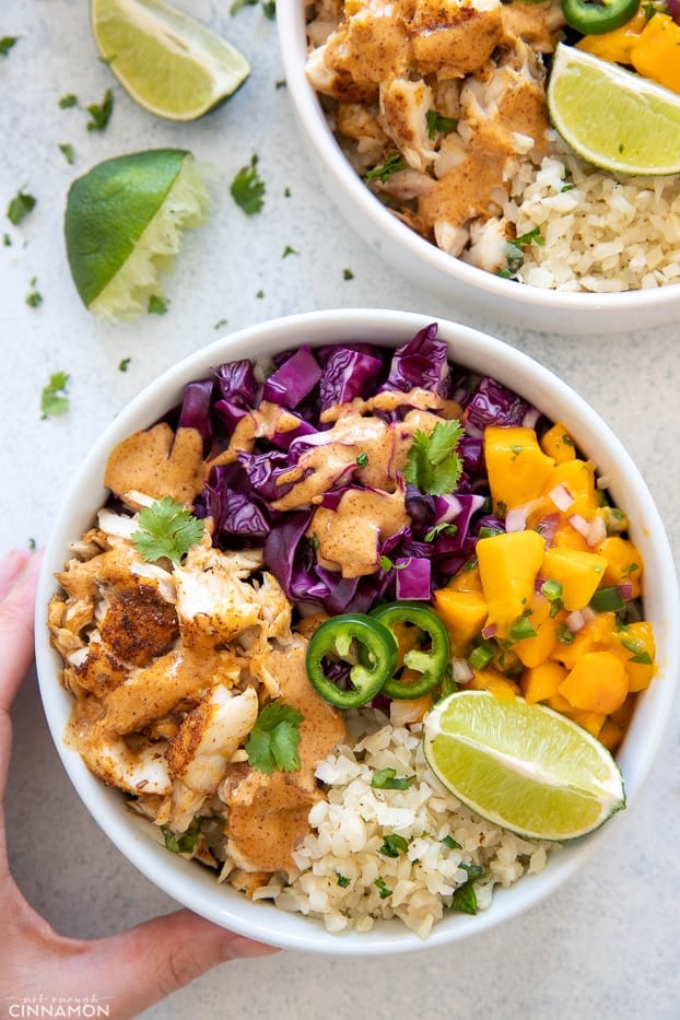 overhead shot of a paleo whole30 fish taco bowl drizzled with chipotle mayo