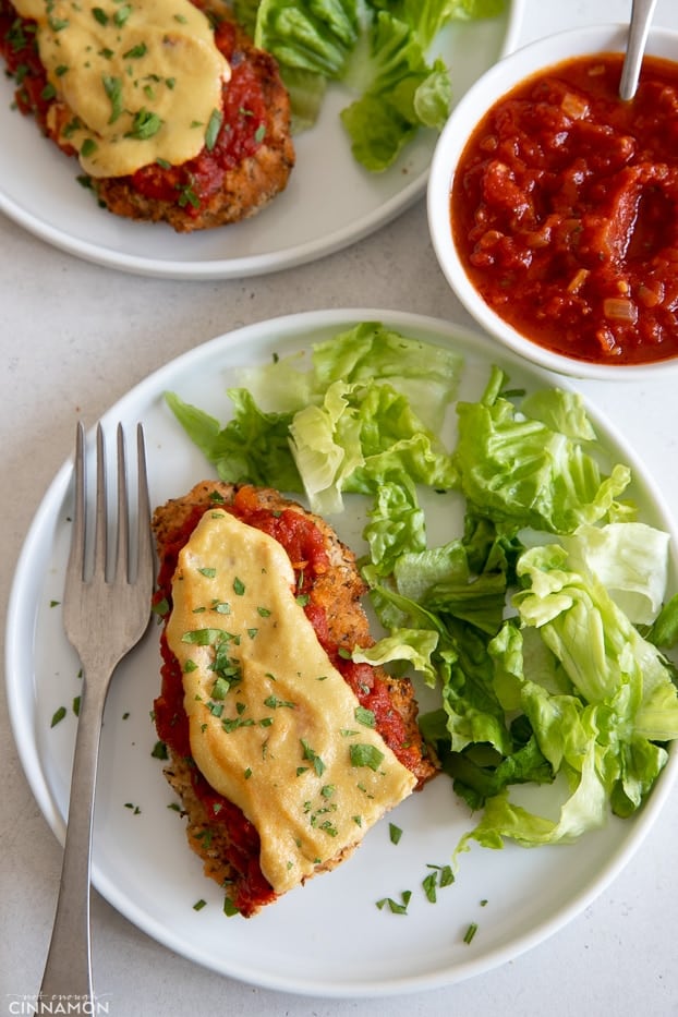overhead shot of healthy chicken parmesan with a side of green butter lettuce