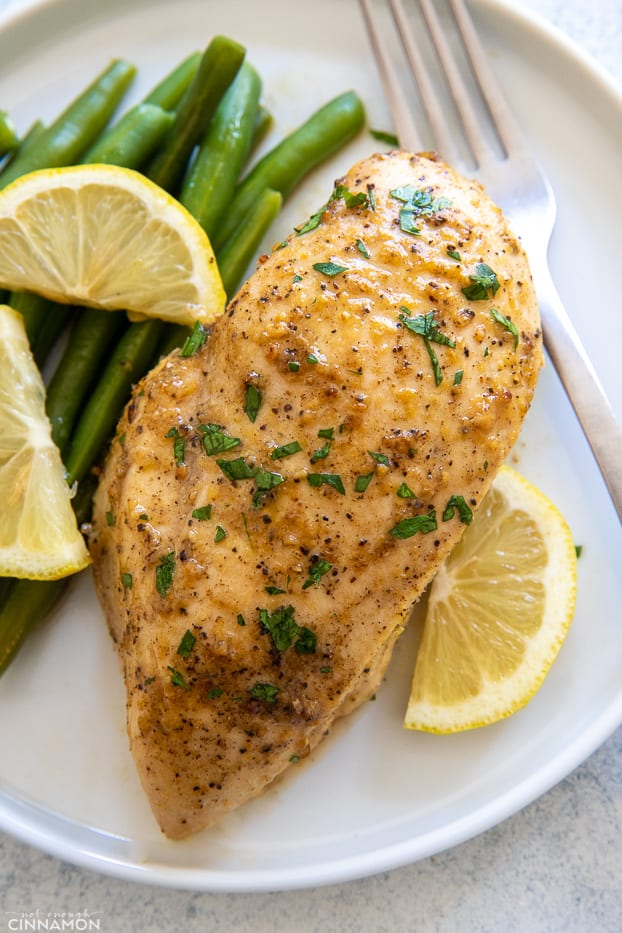 easy baked lemon pepper chicken breast served with a side of green beans