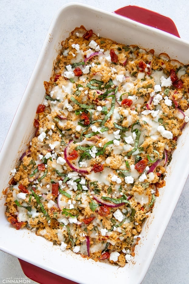 overhead shot of Mediterranean quinoa casserole sprinkled with feta and basil