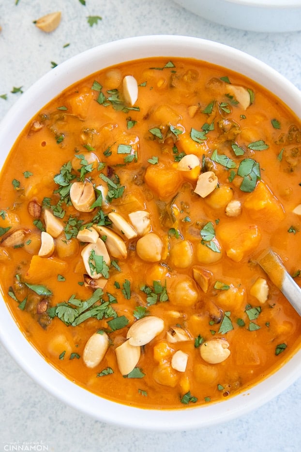 a bowl of healthy vegan West African Peanut Soup with a spoon 