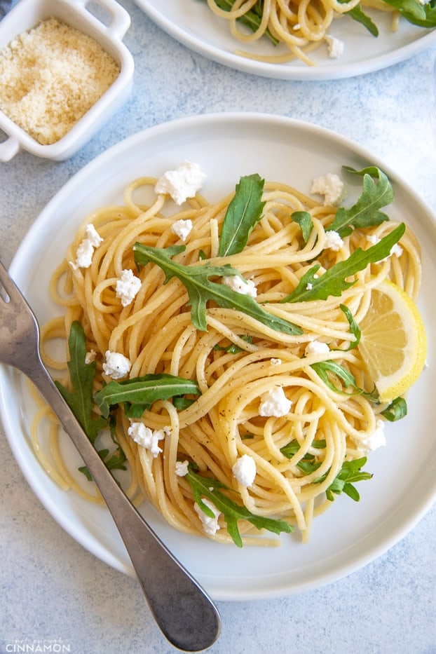 overhead shot of easy lemon pasta with arugula and feta with a fork on the side