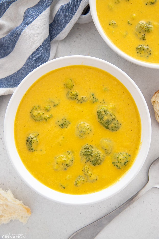 two bowls of easy vegan broccoli cheese soup made with cashew cream