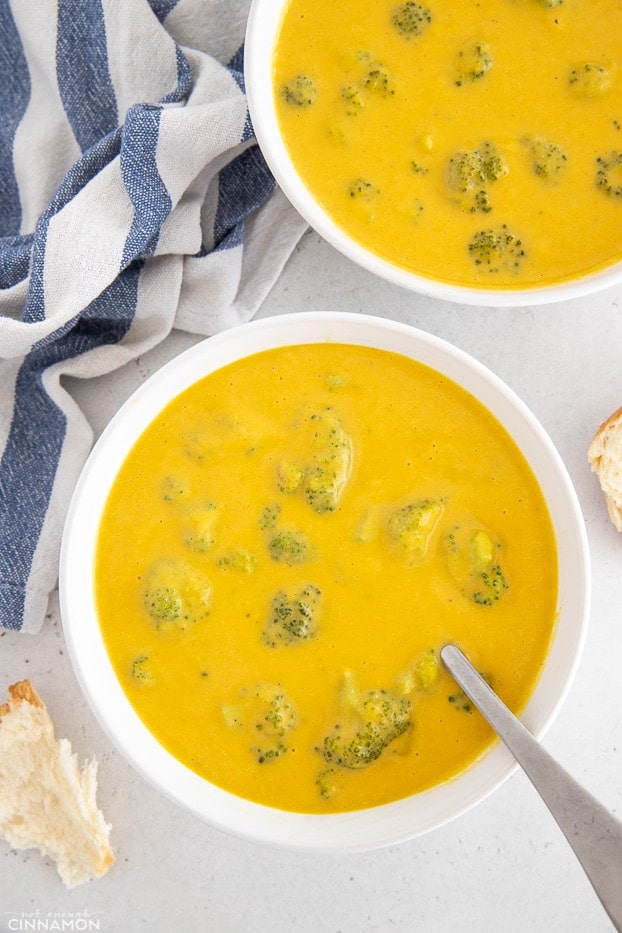 overhead shot of two bowls of vegan broccoli cheese soup 
