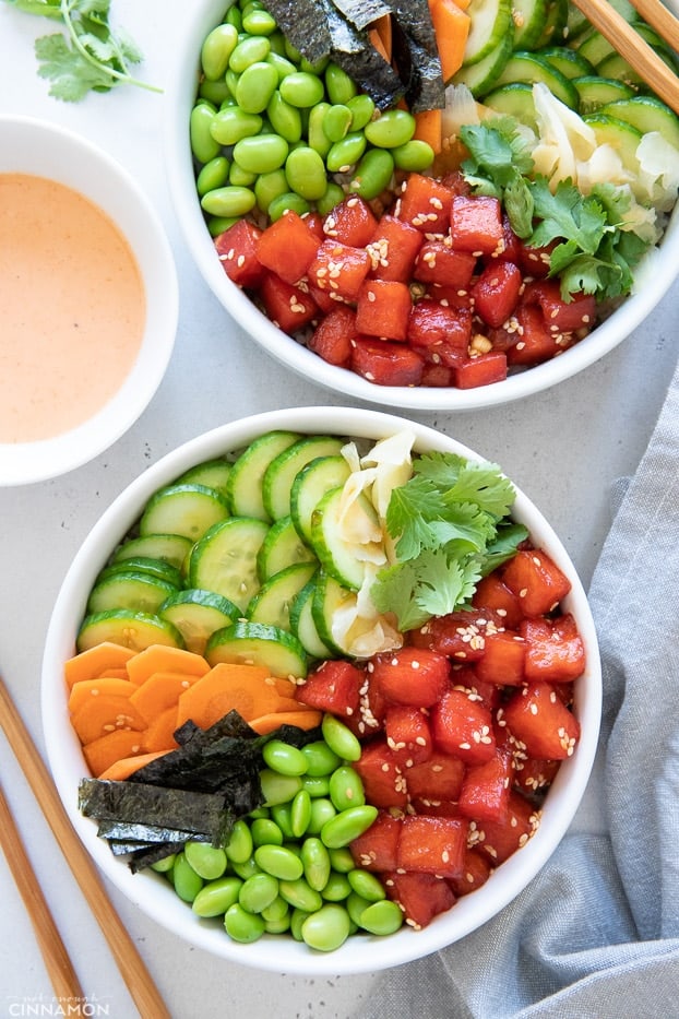overhead shot of two vegan watermelon tuna poke bowls with cucumber, nori and edamame 