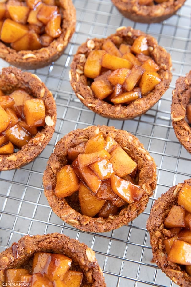 overhead shot of apple crisp cookie cups chilling on a cooling rack 
