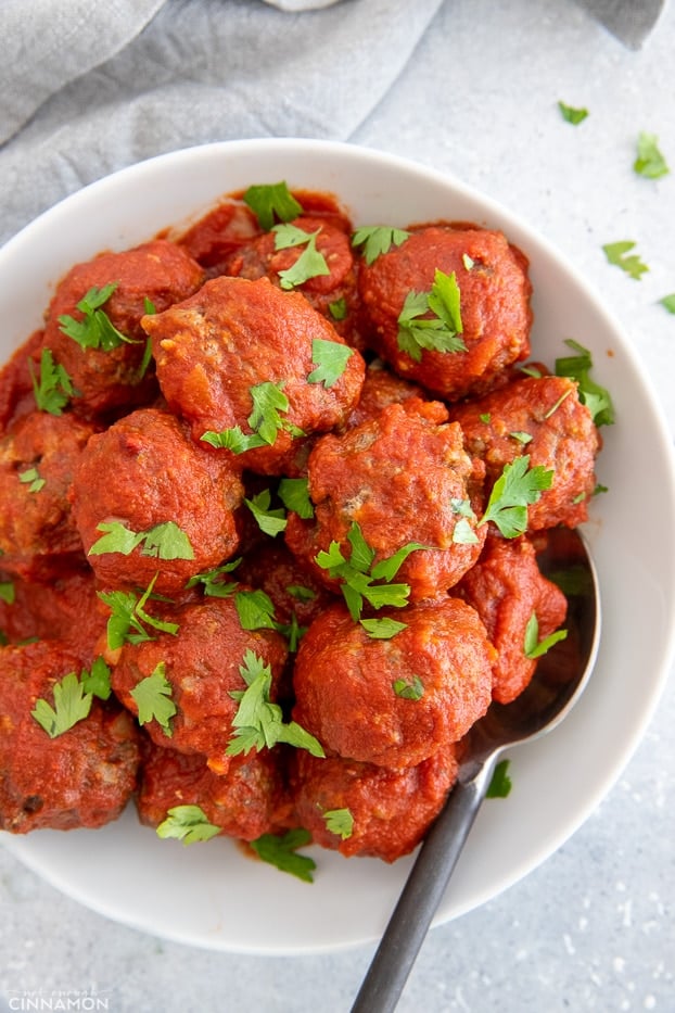overhead shot of a serving of healthy slow cooker beef meatballs served with tomato sauce 