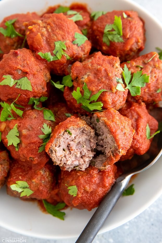 healthy bbq slow cooker meatballs served in a white bowl sprinkled with cilantro 