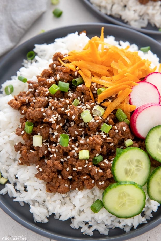side view of Korean Beef Bowls topped with sesame seeds 