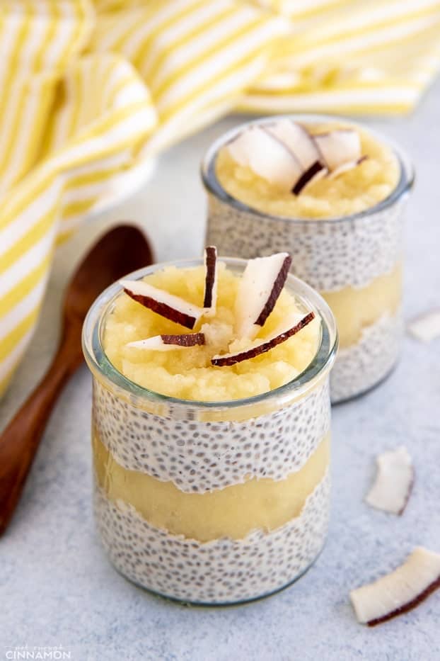 side view of a jar of piña colada chia pudding decorated with toasted coconut