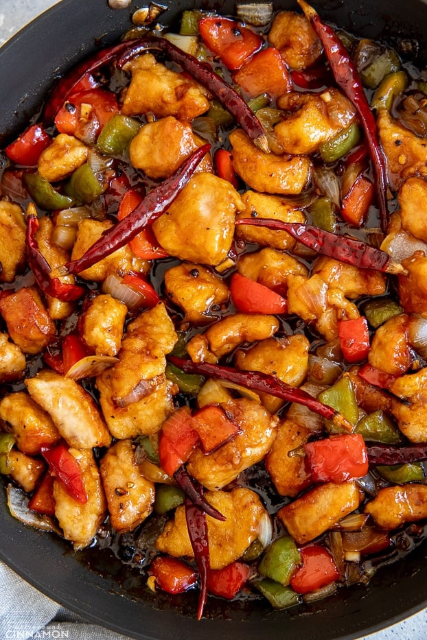 Chinese Szechuan Chicken Stir Fry in a black skillet 