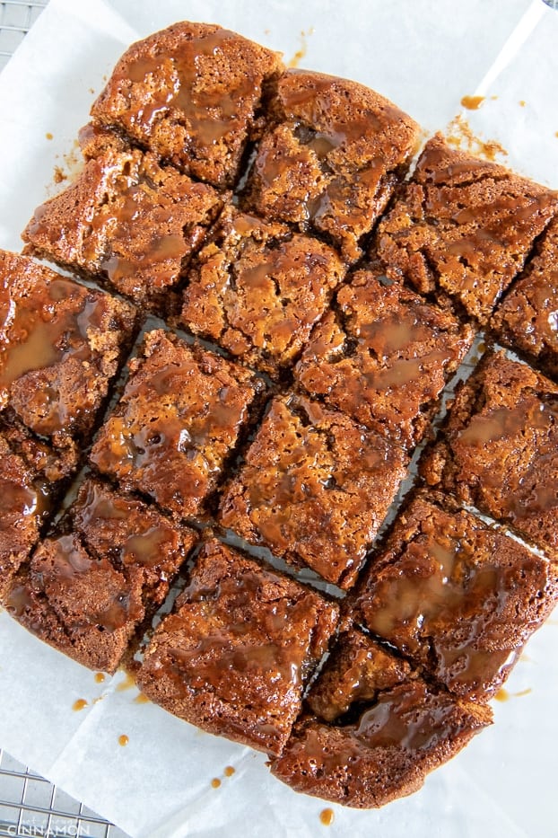 overhead shot of paleo healthy salted caramel blondies drizzled with coconut caramel sauce