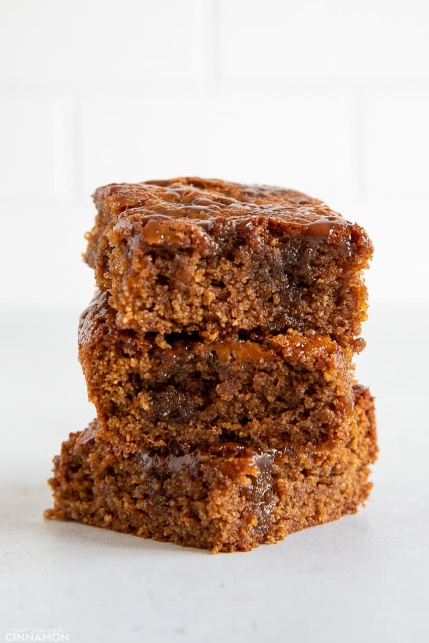 stacked healthy almond flour blondies drizzled with homemade dairyfree caramel 