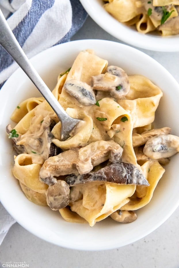 a plate of vegan mushroom stroganoff with a fork inserted