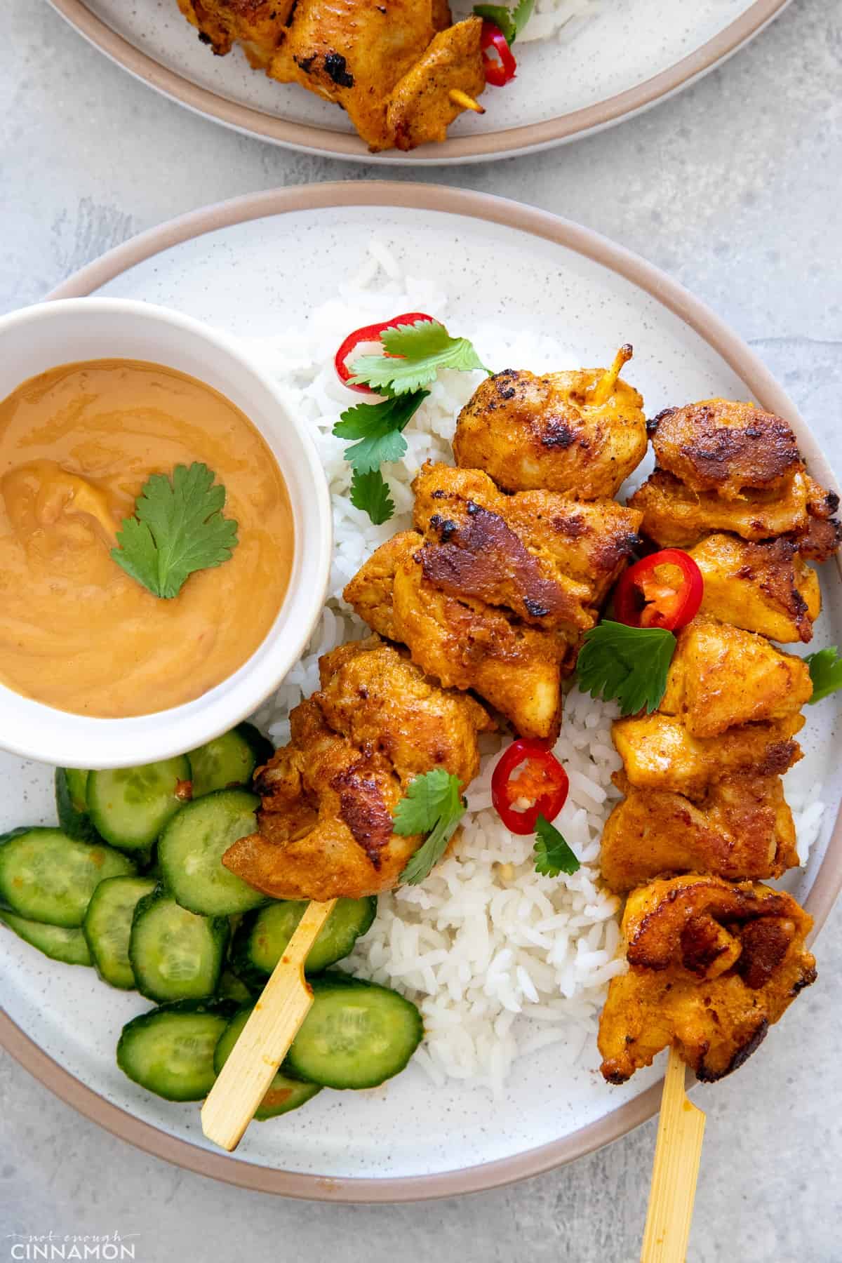 Satay Thai Chicken Skewers served with healthy satay sauce and a side of cucumber salad 