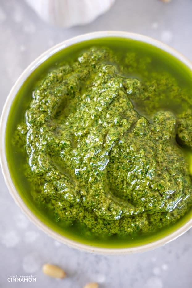 Homemade basil pesto in a white bowl