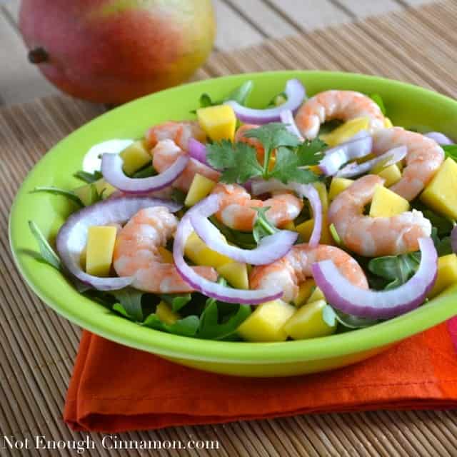 Mango Shrimp Arugula Salad served on a green plate