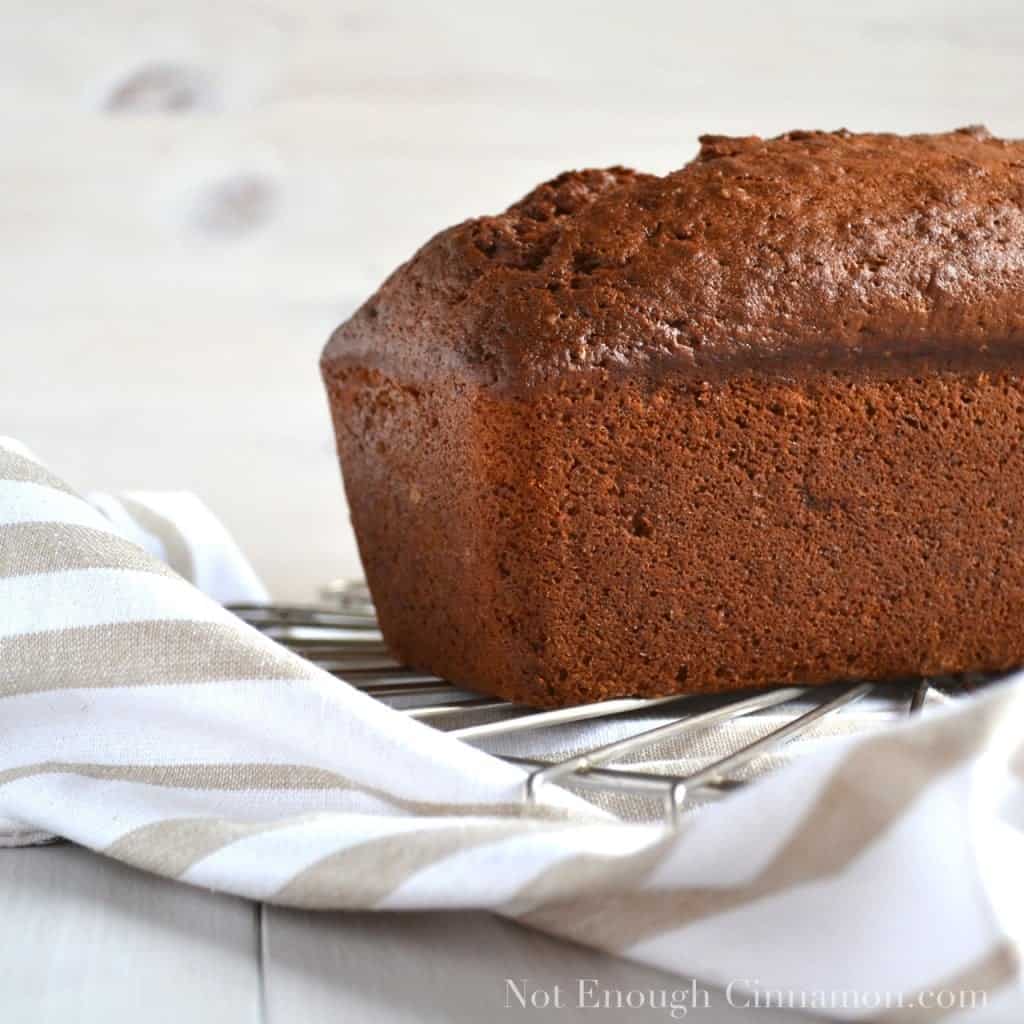 side view of a loaf of banana bread cooling on a rack