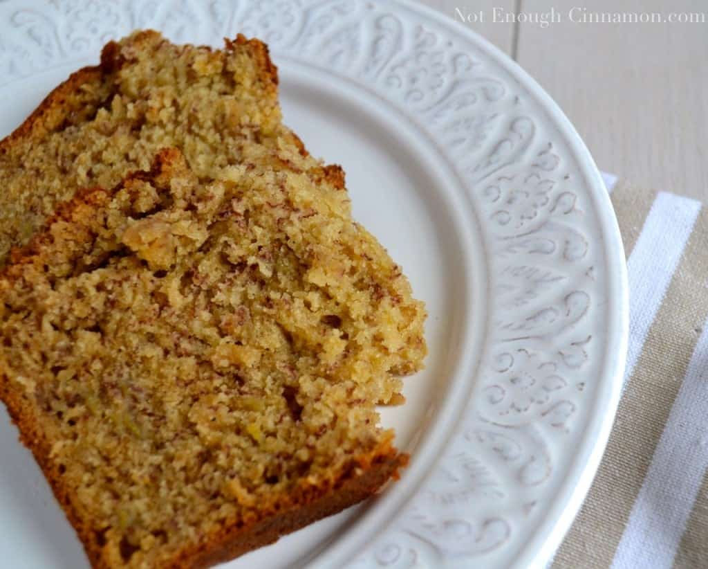 close-up of two moist-looking slices of banana bread on a white plate