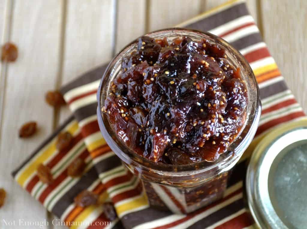 Fig Chutney with apples and raisins filled into a glass jar ready to be sealed