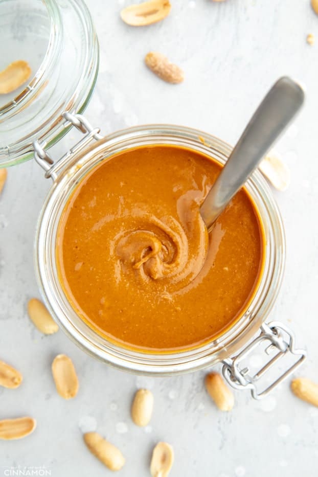 Overhead shot of a jar of homemade peanut butter with a spoon