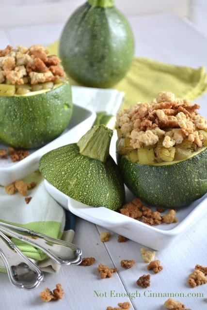 Zucchini Parmesan Crumble served in a baked 8-Ball Zucchini with crunchy Parmesan topping