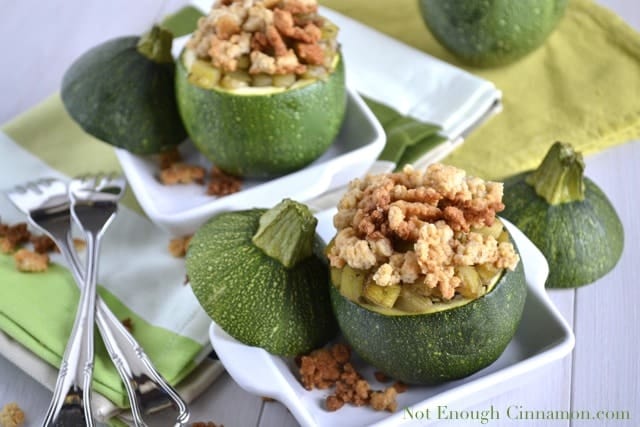 Zucchini Parmesan Crumble served in a baked ball zucchini with the lid lying next to it