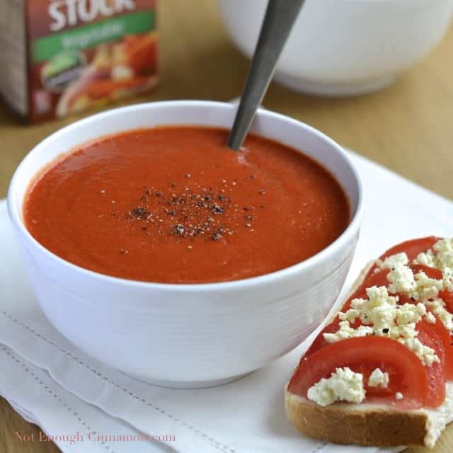 Roasted Bell Pepper Soup in a white bowl with some freshly cracked pepper sprinkled on top